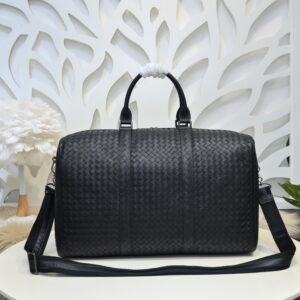 Bottega Veneta's classic Intrecciato woven men's travel bag (black calfskin).