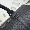 Bottega Veneta's classic Intrecciato woven men's travel bag (black calfskin).